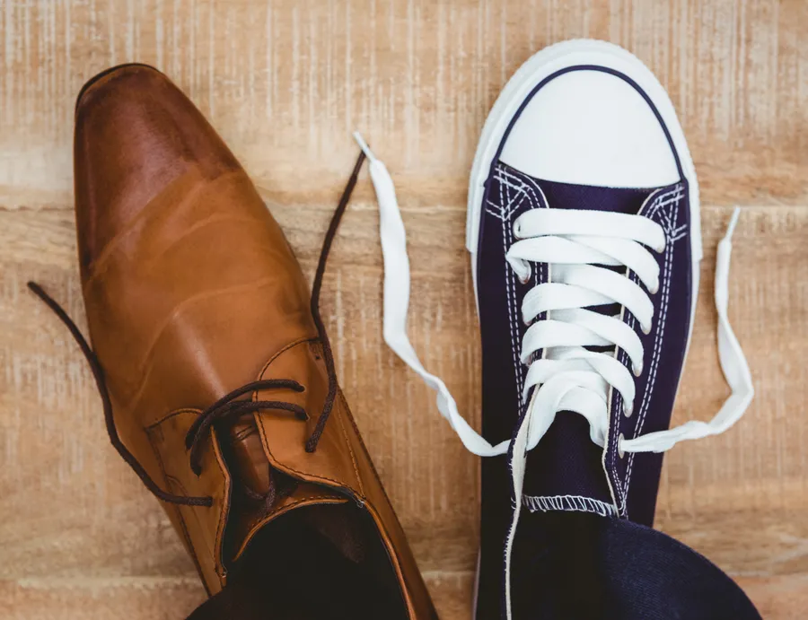 A dress shoe next to a running shoe — whichever you arrive in works here